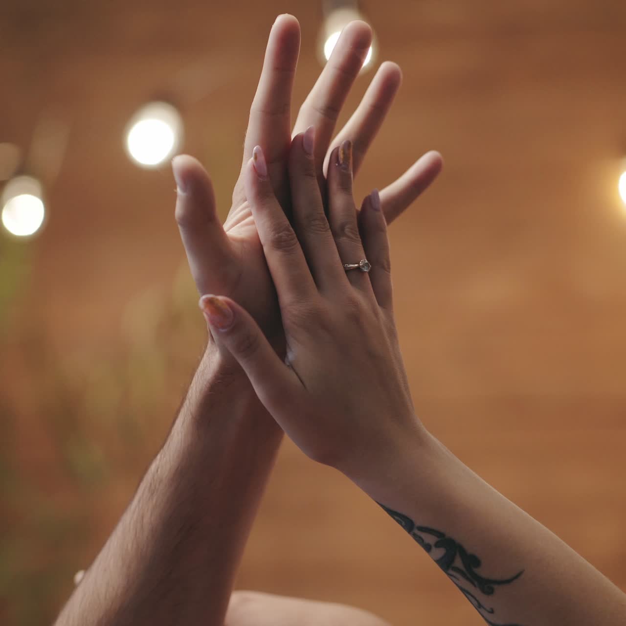 hands of man and woman are flirting with each other with motions in the room on the eve of St. Valentine's Day
