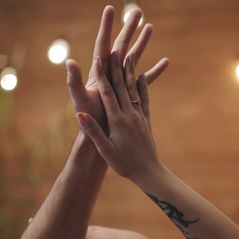 hands of man and woman are flirting with each other with motions in the room on the eve of st. valentine's day