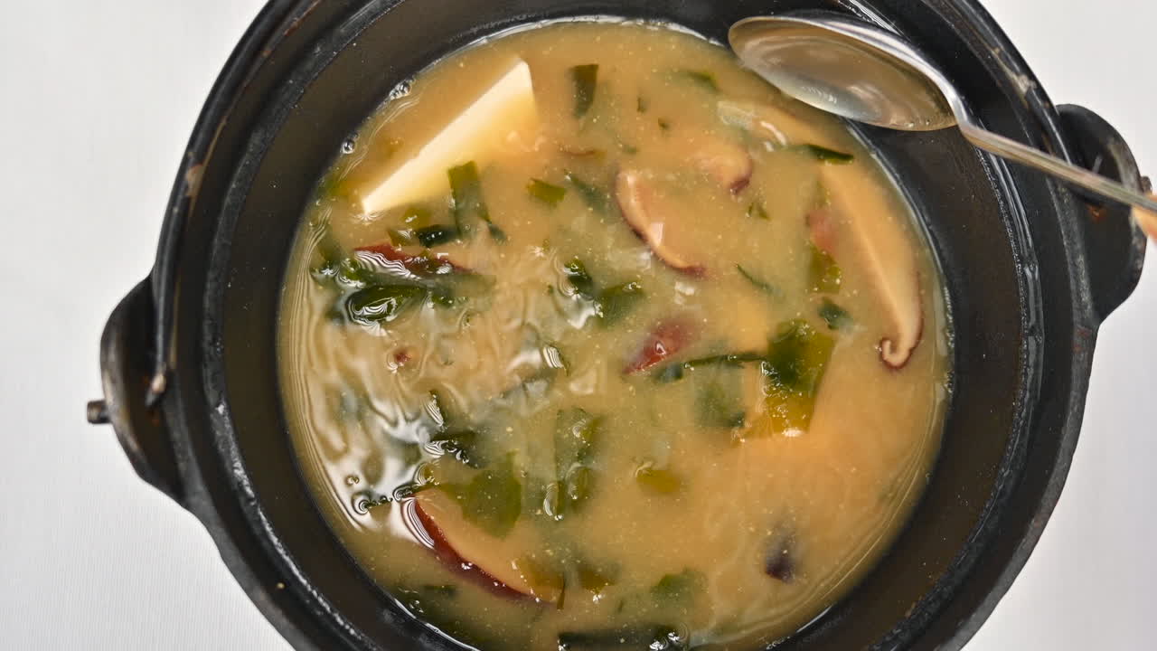 Japanese seaweed miso soup with tofu cheese, slow motion stir
