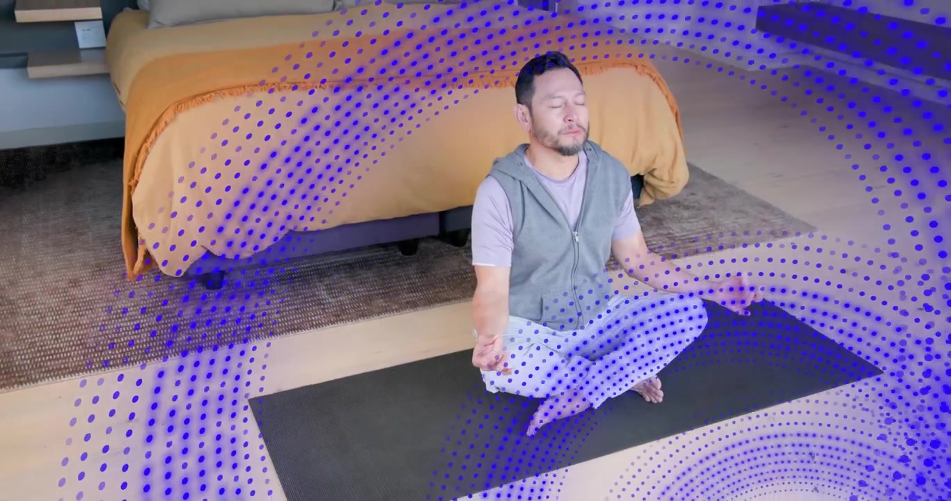 Man meditating on yoga mat spiraling blue dots coalescing into orbs orbiting torso guiding wellness