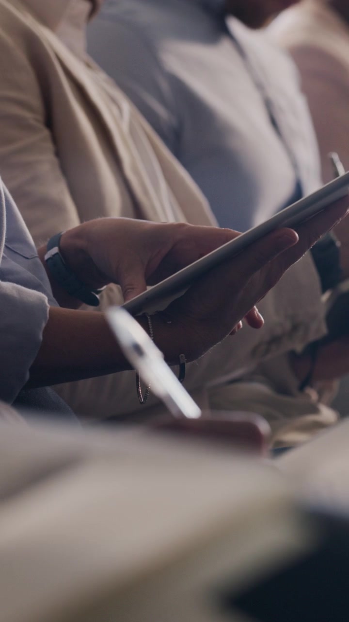 Business Professionals Using Digital Tablets During a Conference