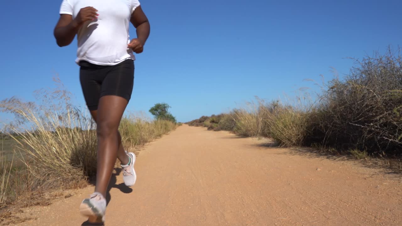 Black woman running in the sand