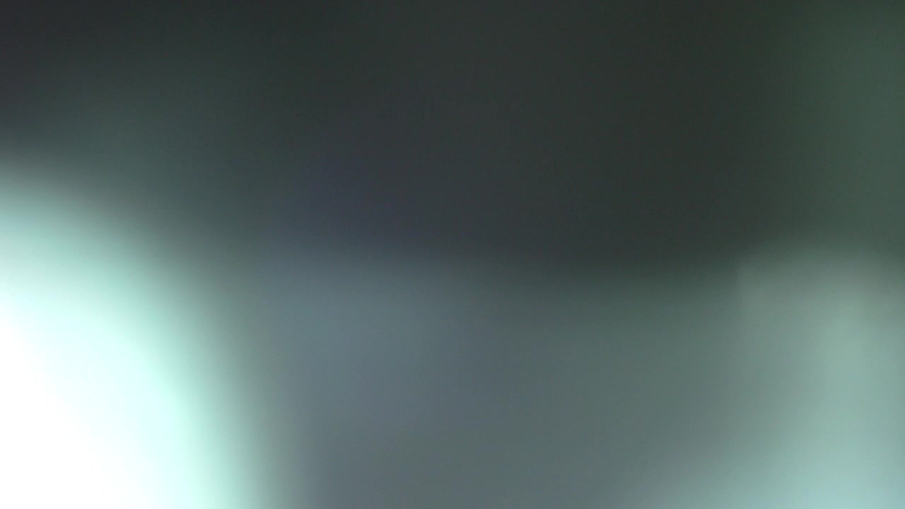 Brief Light Flash and Lens Flare on Black Background