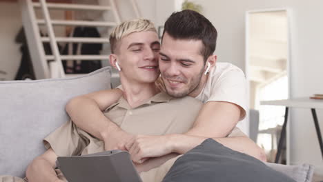 couple hugging and watching film using tablet