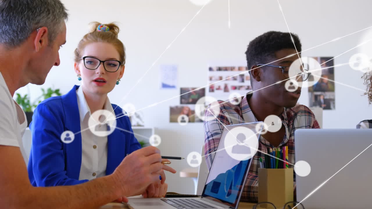 Animation of network of digital icons over diverse colleagues discussing at office