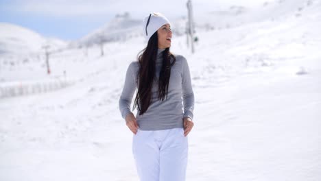 attractive young woman standing in winter snow