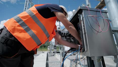 electrical engineers inspect the electrical systems at the equipment control cabinet