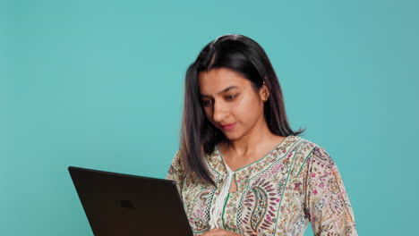 Woman-composing-email,-typing-on-laptop,-frustrated-with-malfunctioning-keyboard