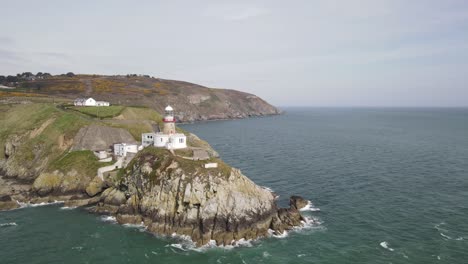 baily lighthouse in howth - lighthouse on the southeastern part of howth head in county dublin, ireland - aerial shot