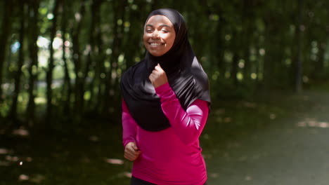 woman running in park wearing hijab