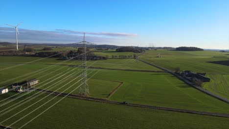 Green-Energy-in-Action:-Aerial-View-of-Windmills-and-Powerlines-in-Sauerland,-Germany's-Power-Grid