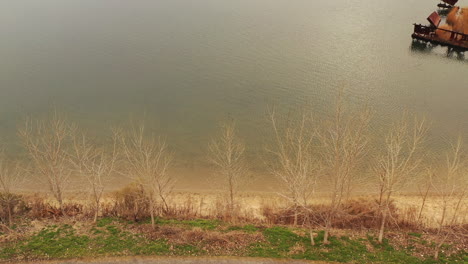 an aerial view over a park with a creek