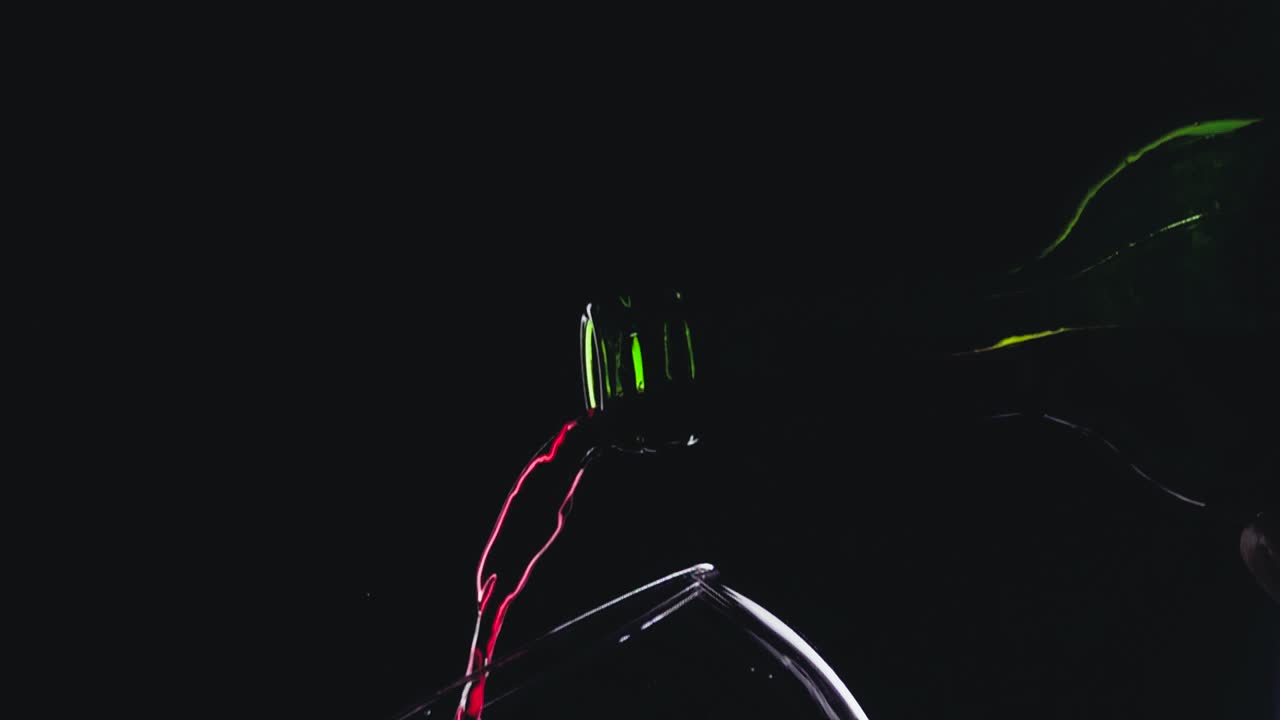 Red wine in wineglass on black background