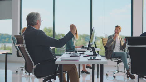 team celebrating success in modern office