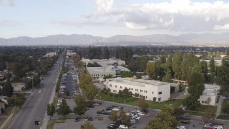 4K-cinematic-flight-over-Los-Angeles-Valley-College-in-Van-Nuys-California-with-a-Southwest-jet-plane-approaching-Burbank-Airport-in-the-background