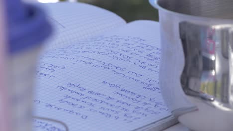 Close-up-shot-of-recipe-notebook-on-table