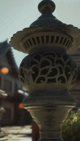 close-up of an ornate japanese stone lantern in a garden setting