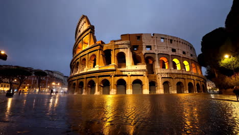 colosseum in rome at night, wet pavement reflections