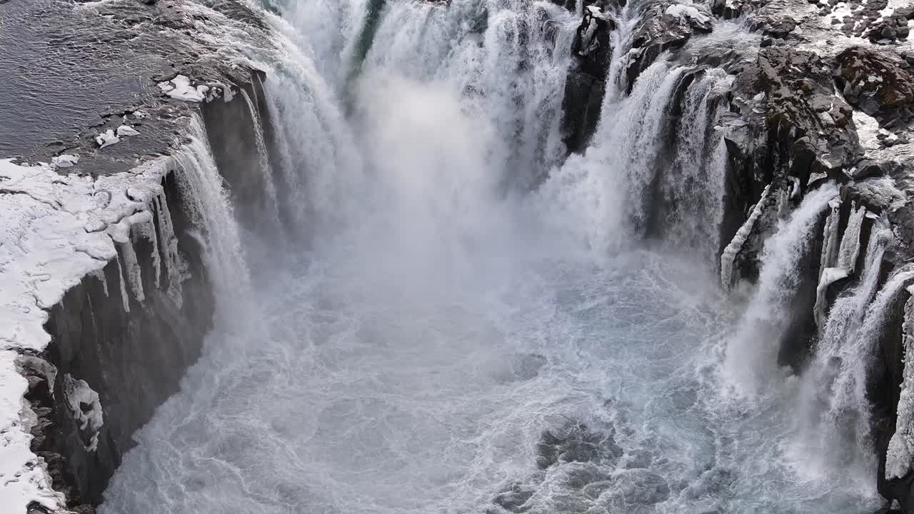 Winter flow crashes over the basalt cliffs of Selfoss waterfall in northeast Iceland