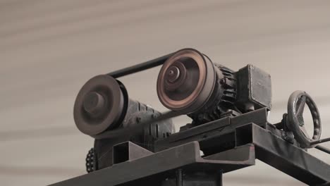 rotating parts with gears of industrial equipment at factory.