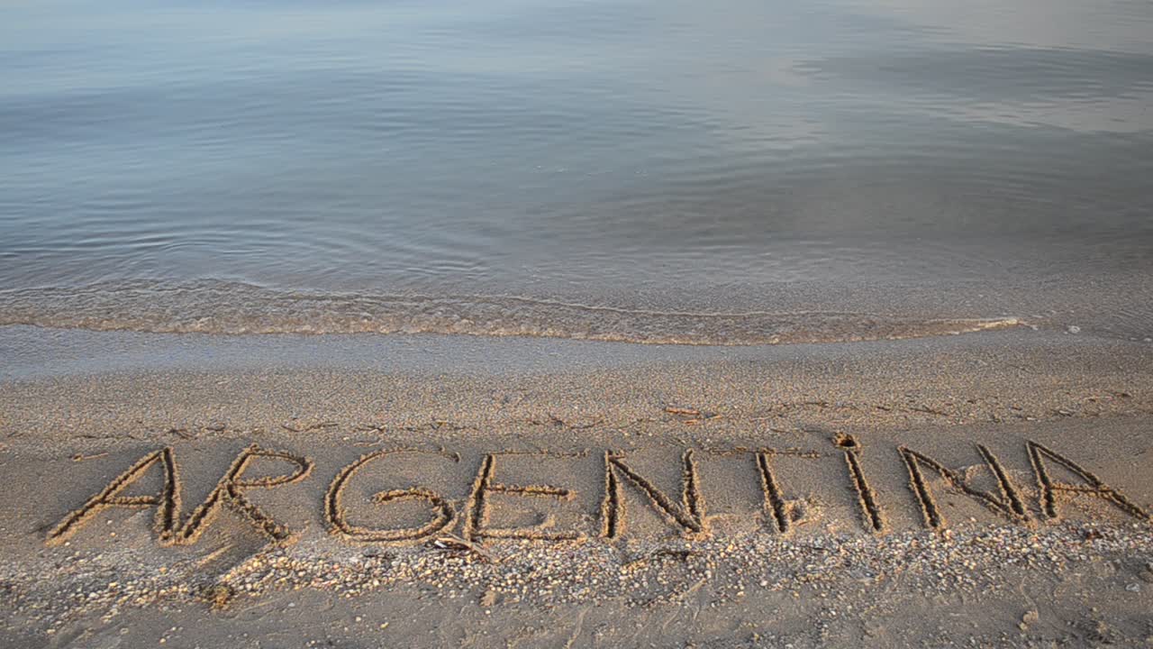 The inscription Argentina on sand. Inscription on sand, the beach