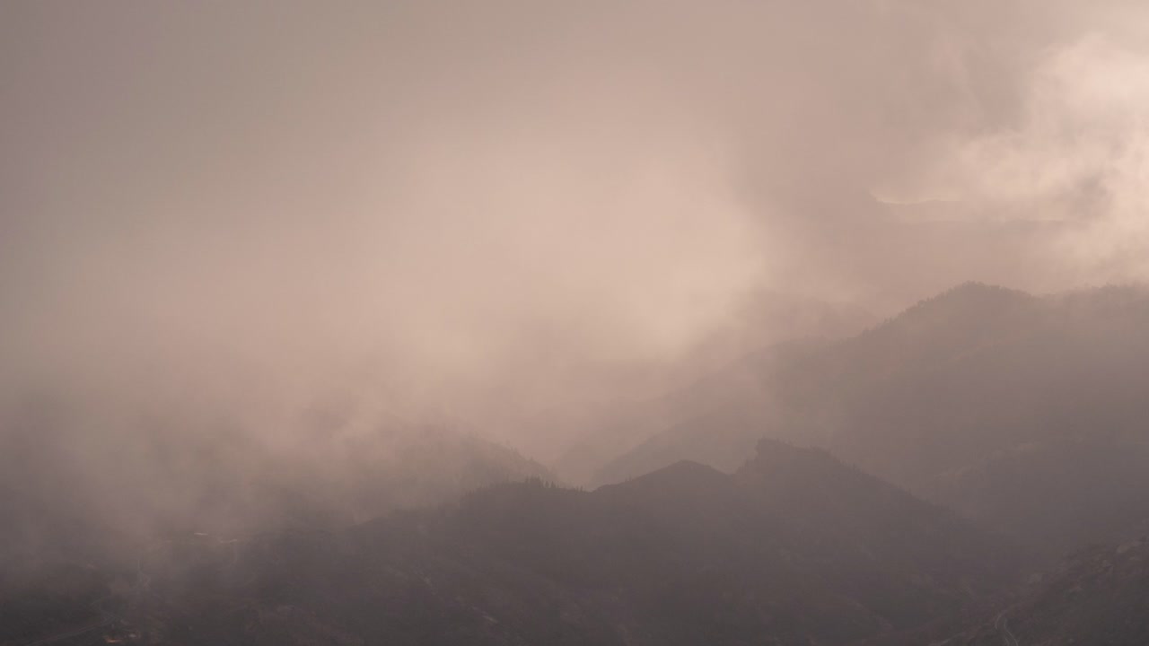 Dramatic timelapse of a cloudy valley in Gran Canaria at sunset. Warm golden light breaks through the mist, creating a breathtaking and cinematic scene. Perfect for nature, travel, and landscape