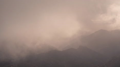 dramatic timelapse of a cloudy valley in gran canaria at sunset. warm golden light breaks through the mist, creating a breathtaking and cinematic scene. perfect for nature, travel, and landscape