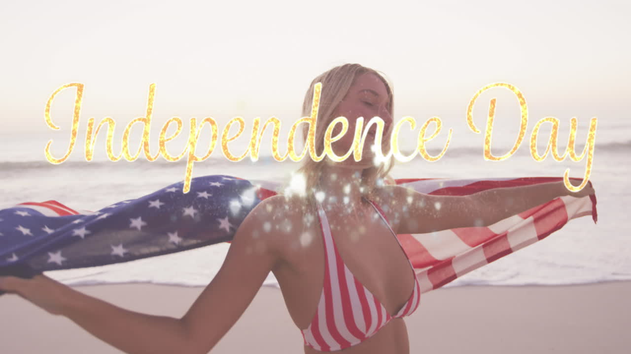 animación del texto del día de la independencia sobre una mujer sonriente envuelta en la bandera estadounidense en la playa