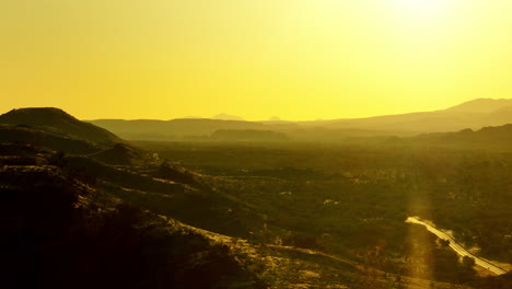 telephoto drone flyover simpson desert with bright yellow sunlight haze, 4k australia
