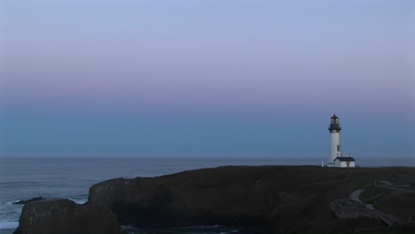 A-Lonely-Lighthouse-Flashes-Its-Signal-At-A-Quiet-Sea