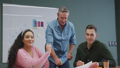 Portrait-of-happy-diverse-business-people-looking-at-camera-at-office