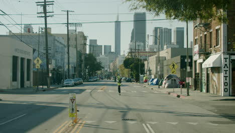 urban street scene with a person walking and downtown skyline