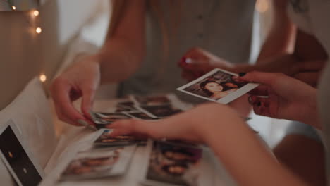 happy teen girls looking at photos at home having fun sharing memories hanging out together