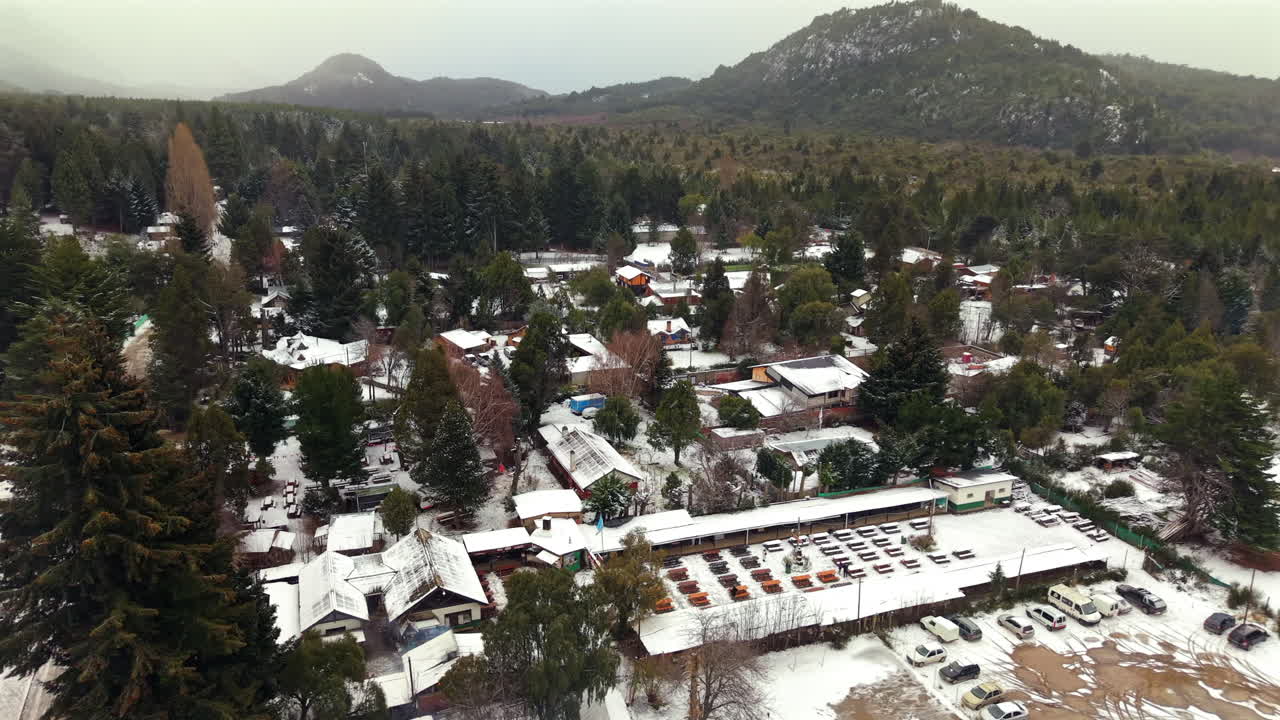 Drone View Picturesque Snowy Mountain Village in Bariloche, surrounded by forests and hills, Argentina