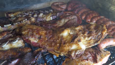 ribs, beef, chicken and chorizos being roasted in traditional argentinian asado