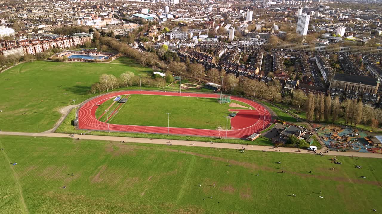Aerial view flying over Parliament hill athletic running track oval sporting loop landmark in London
