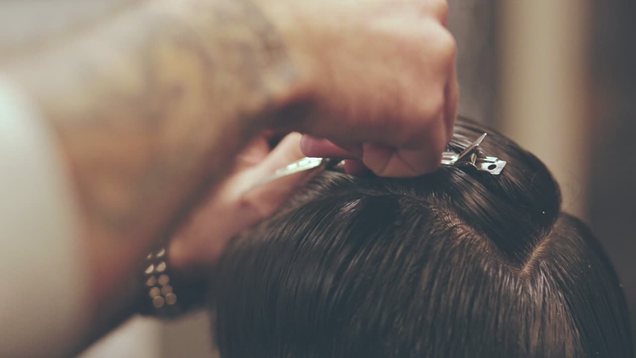 Hairdresser using hair clippers. Male hairdressing. Hairstyle. Hair barrette