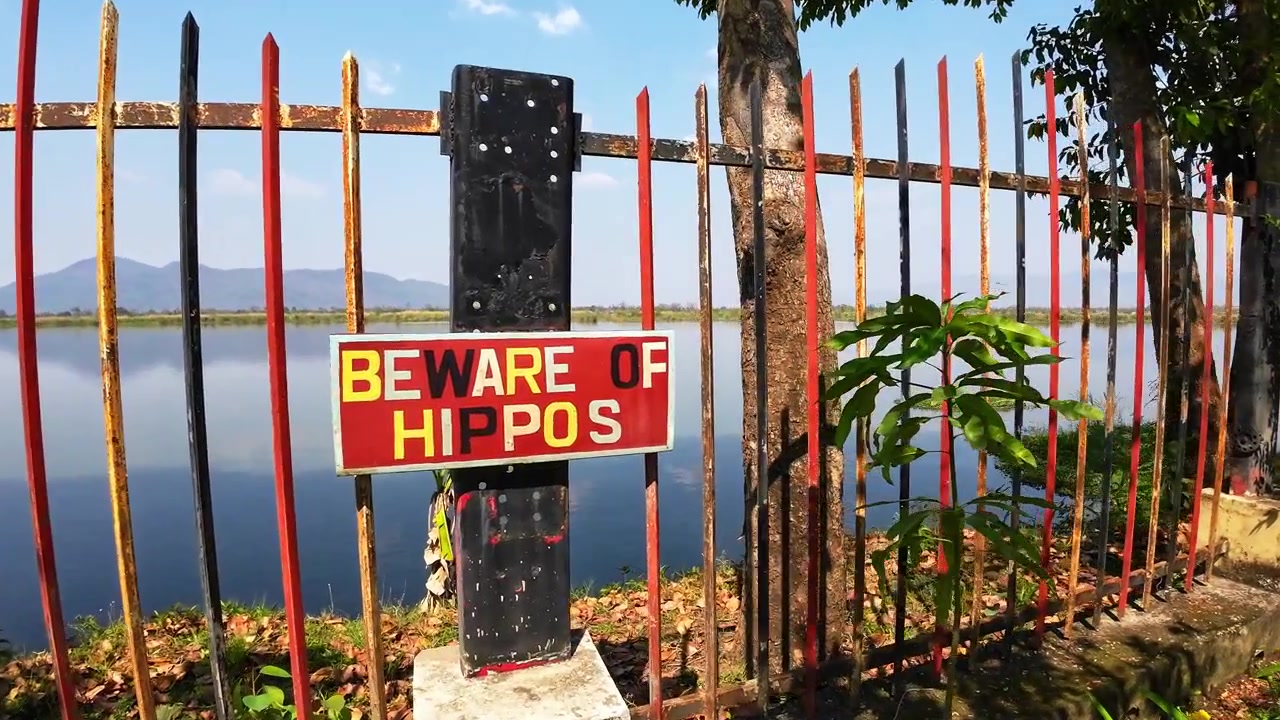 A warning sign overlooks the Shire River in Liwonde National Park, in Malawi Africa.