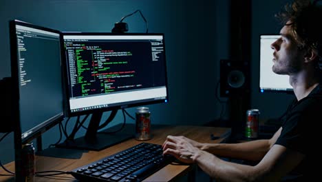 coding session in a dimly lit room with multiple monitors and focused concentration on programming tasks