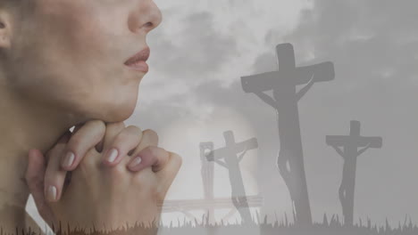 praying person with crucifixion scene animation over cloudy sky background