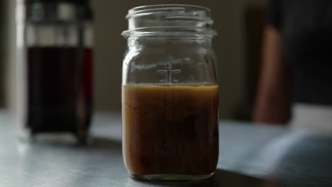 Woman-pours-cream-in-coffee