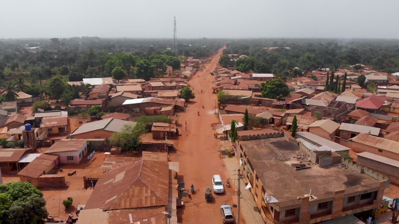 Ouidah Benin West Africa city, roads houses covered in red dust, aerial drone