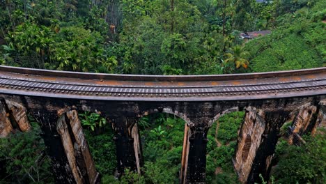 stunning aerial drone footage of the famous nine arches bridge in ella, sri lanka.