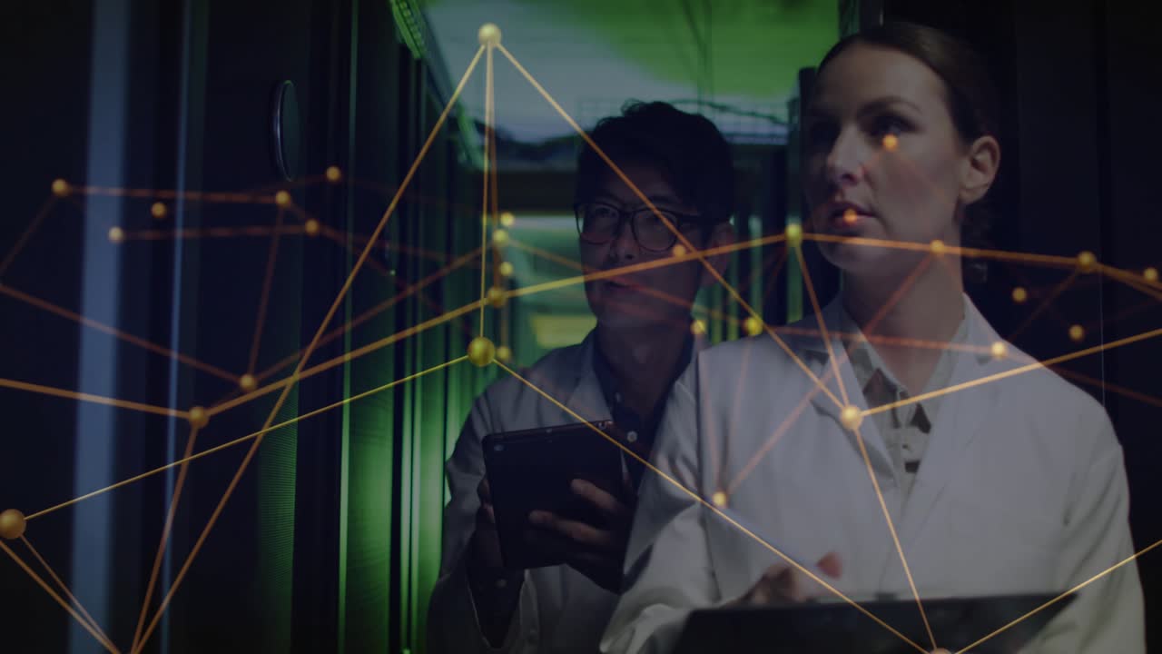 Female tech leading, male tech following, tapping tablet activating data overlay, checking racks