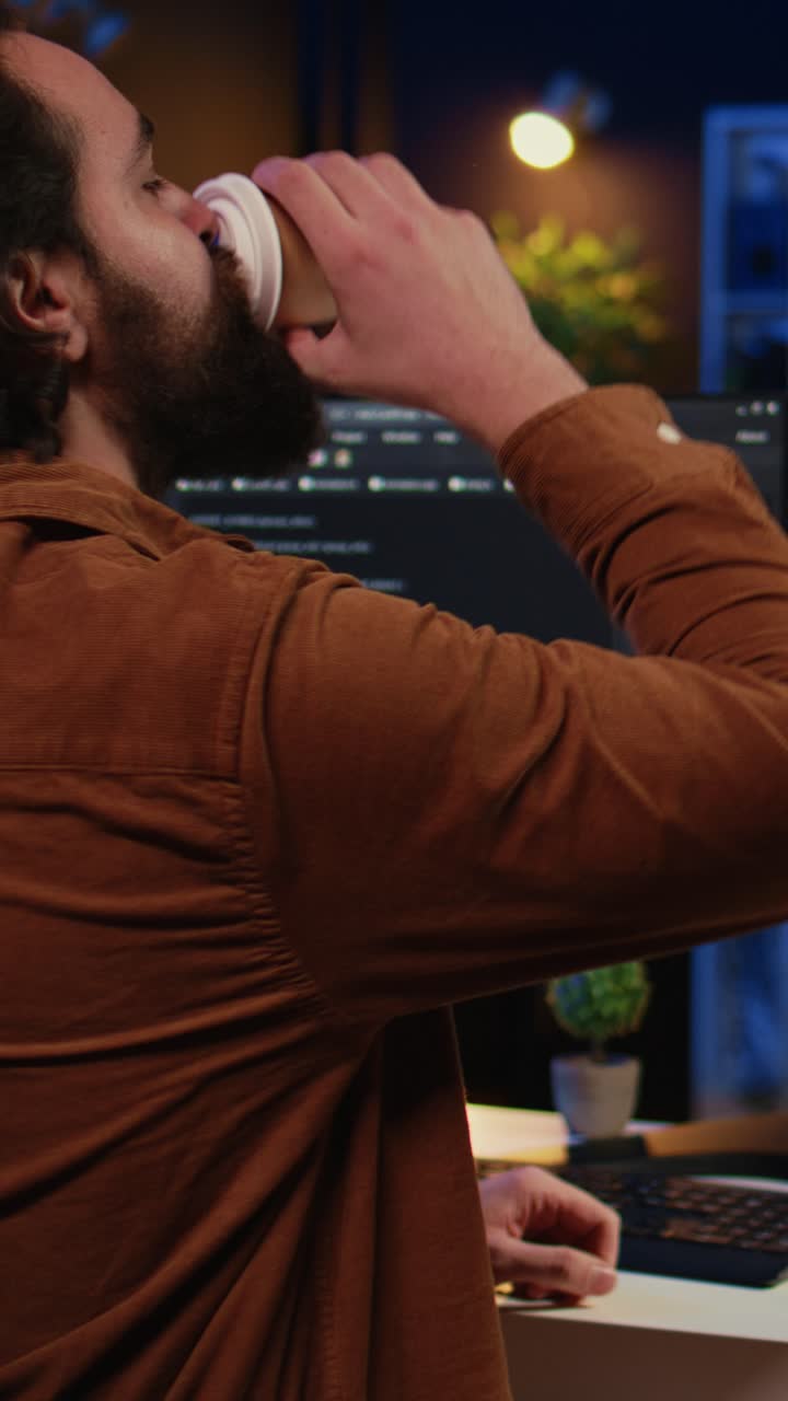 Software Developer Working Late Night on Computer and Drinking Coffee