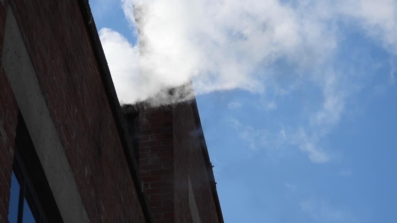 Smoke coming out of a building. Static, low angle