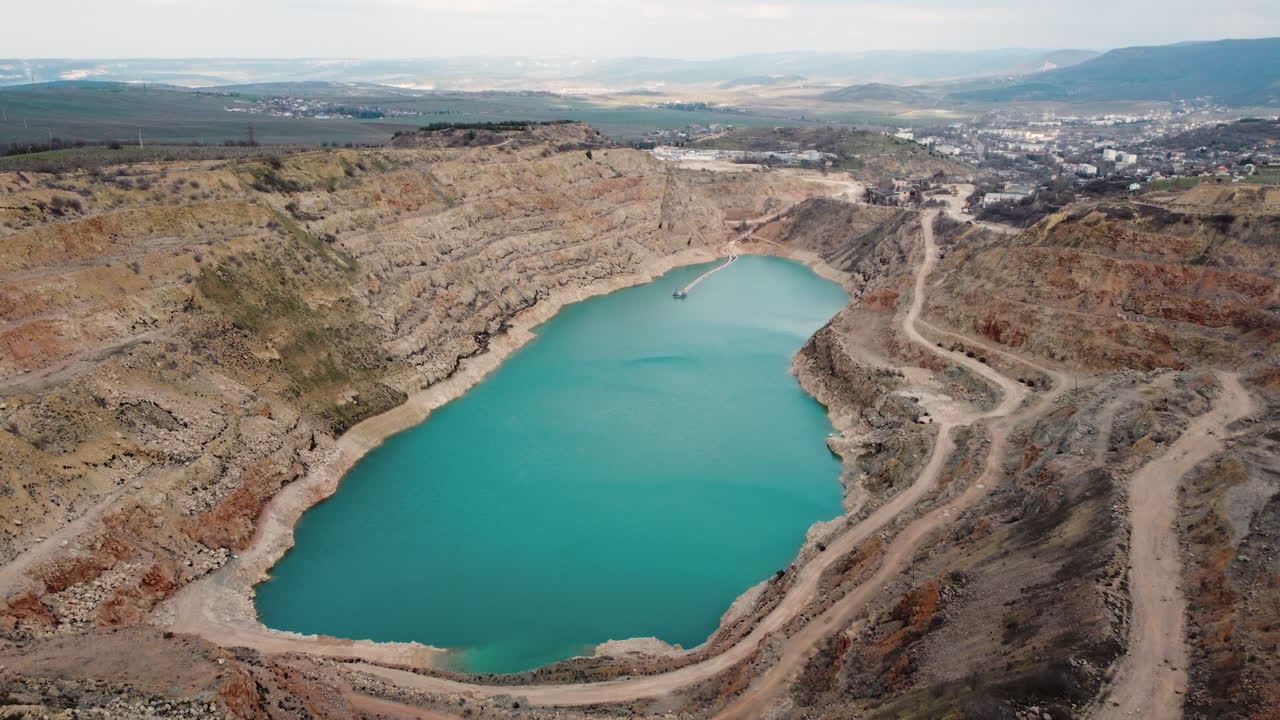 Aerial view of a quarry lake with surrounding landscapes