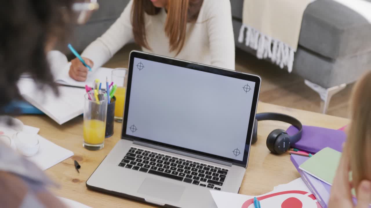 Diverse teenager girls friend, laptop with copy space and learning together at home, slow motion