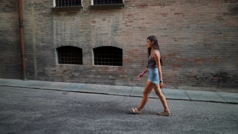 young woman walking in a city street