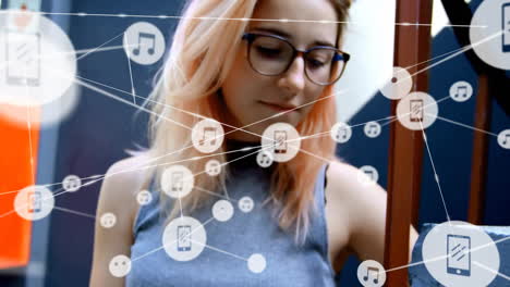 Animation-of-network-of-connected-icons-in-circles-over-happy-caucasian-woman-using-smartphone